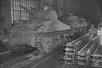 “The new M-4 tanks which will soon be hurling their might against the Axis roll toward the end of the production line in the Schenectady, New York, plant of the American Locomotive Company”