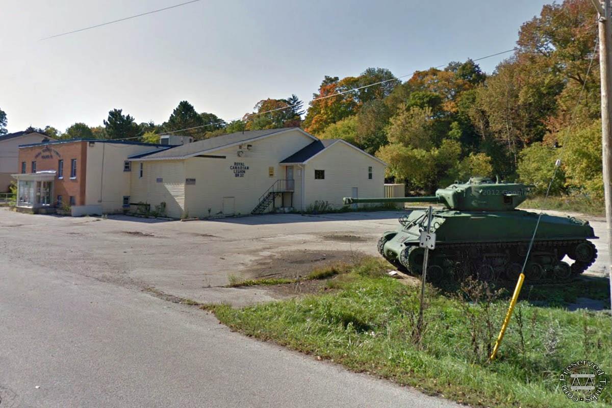 Legion building visible behind tank