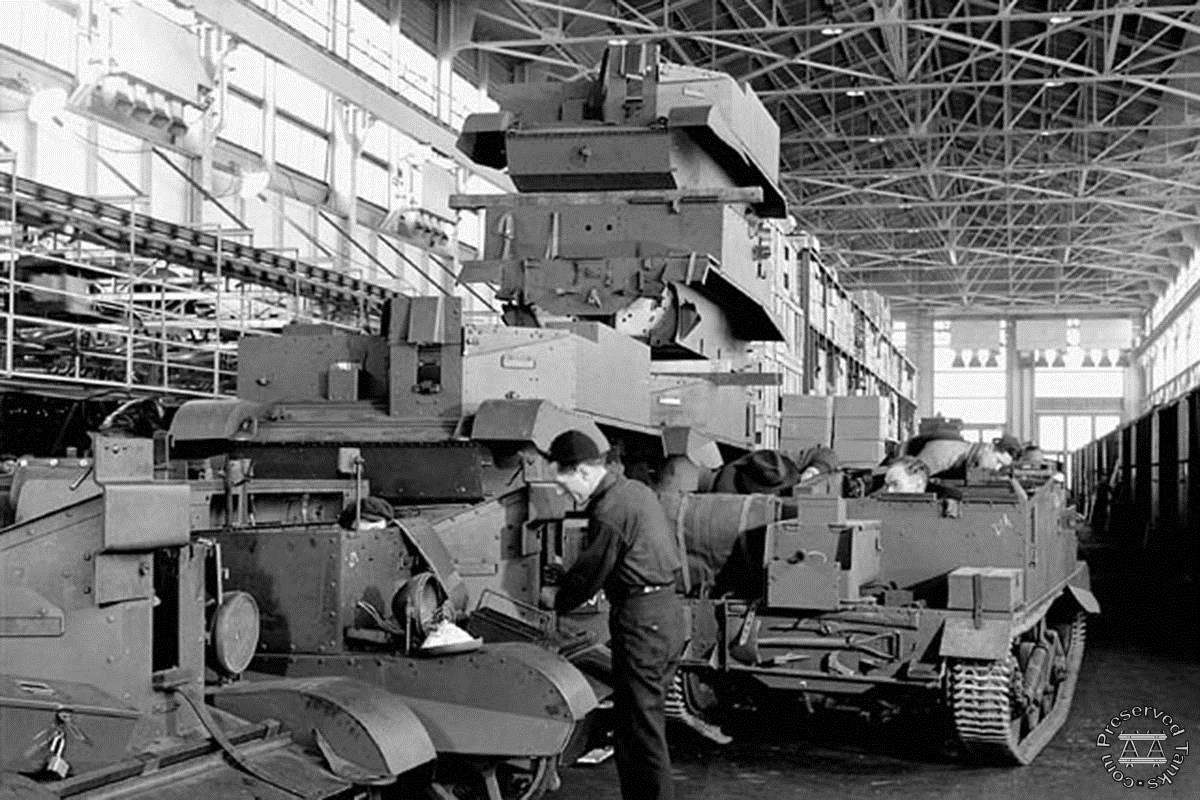 "Workmen assemble universal carriers (army vehicles) on the assembly line at the Ford Motor Co. plant"