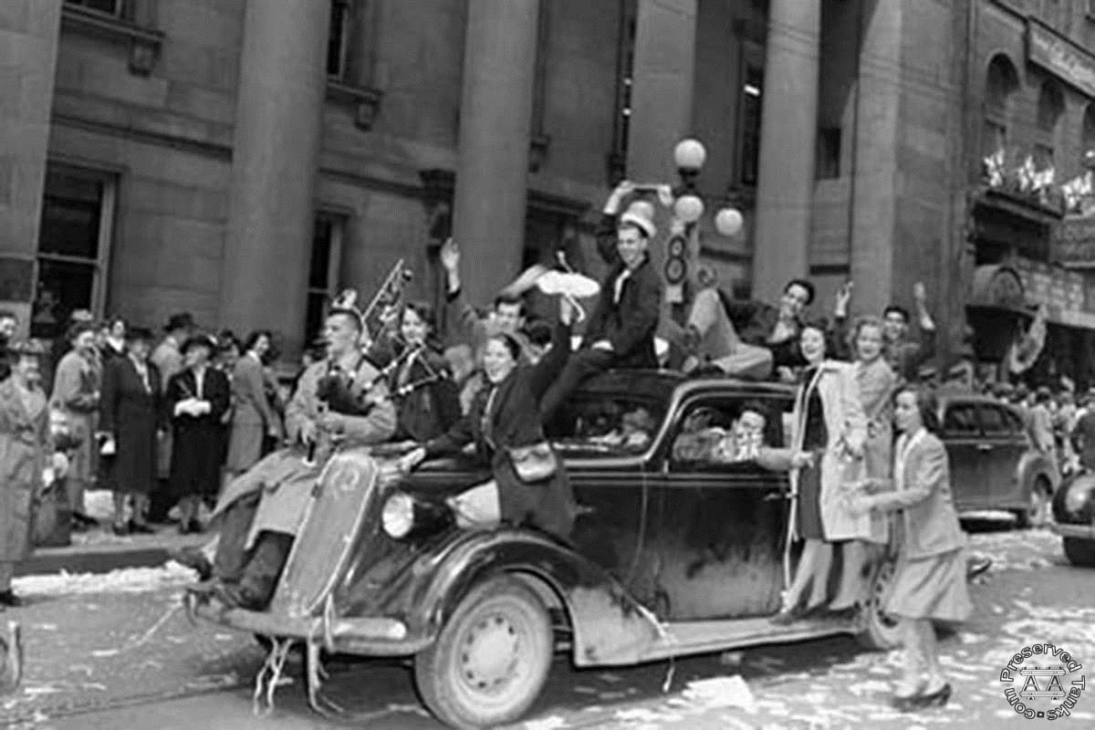 "Military personnel and civilians celebrating V-E Day on Sparks Street, Ottawa, 8 May 1945"